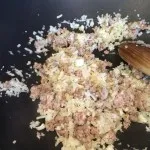 Adding cauliflower rice and salt after the meat gets heated in the pan in Boston, MA