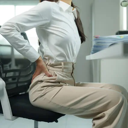 Business woman at desk lower back pain