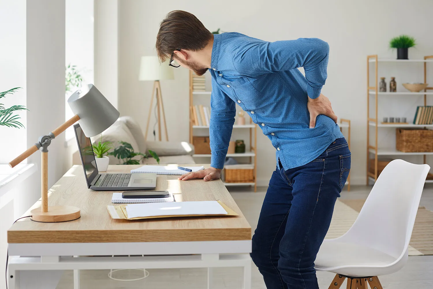 man suffering from lower back pain from pinched nerve after his work