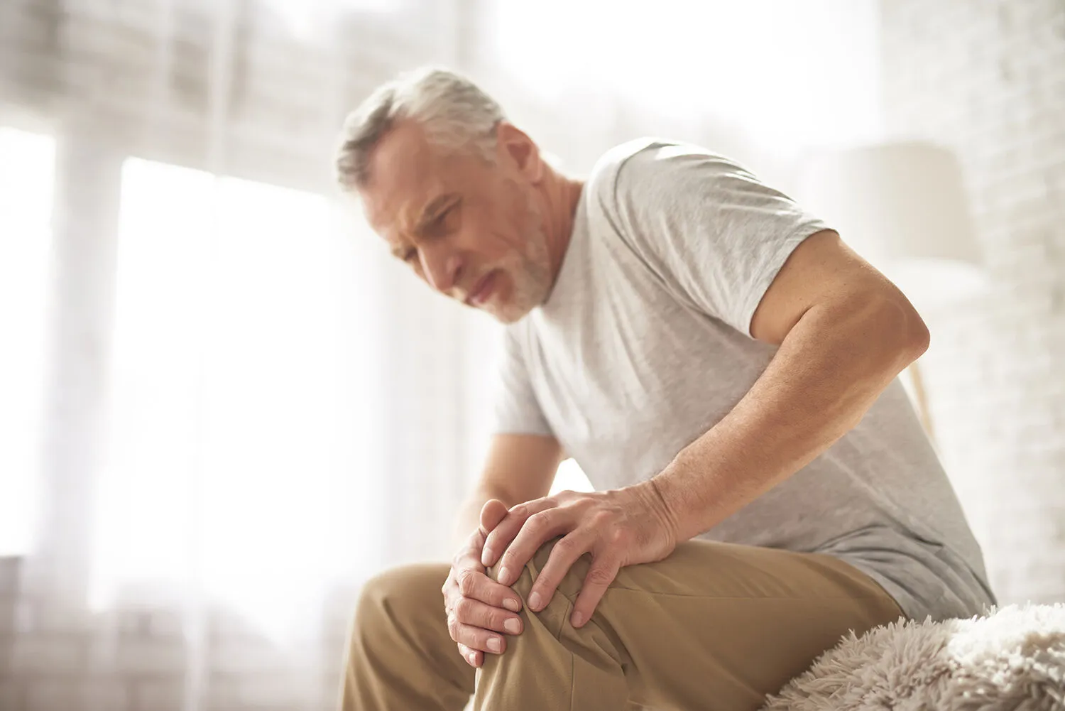 old man suffering from knee pain