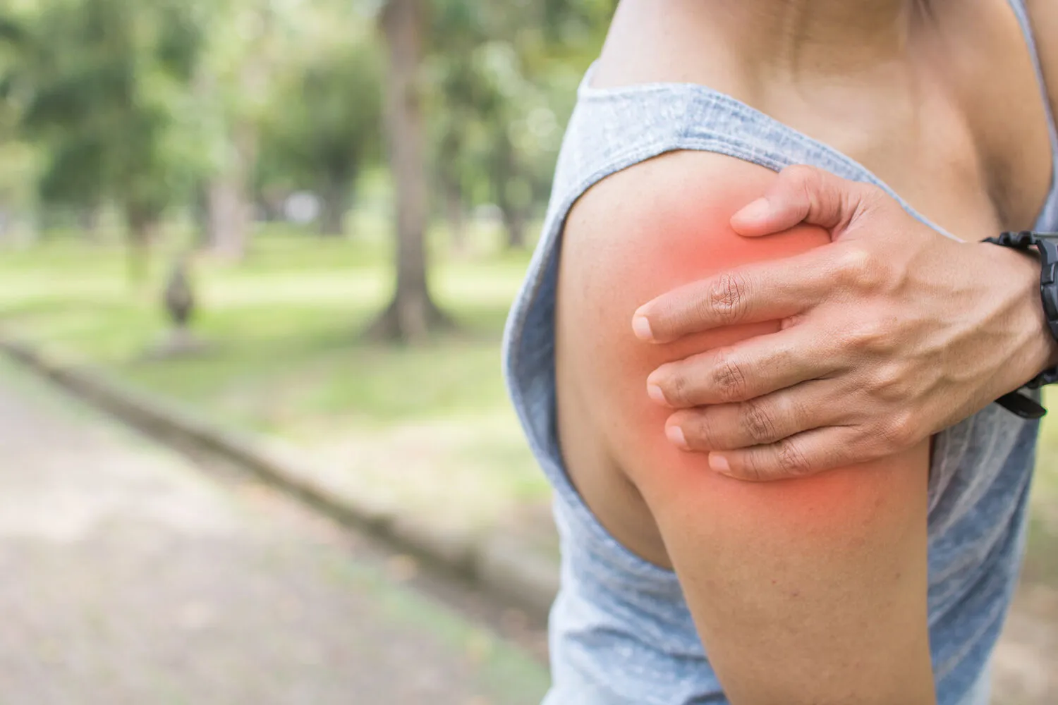 woman having a shoulder pain after walking