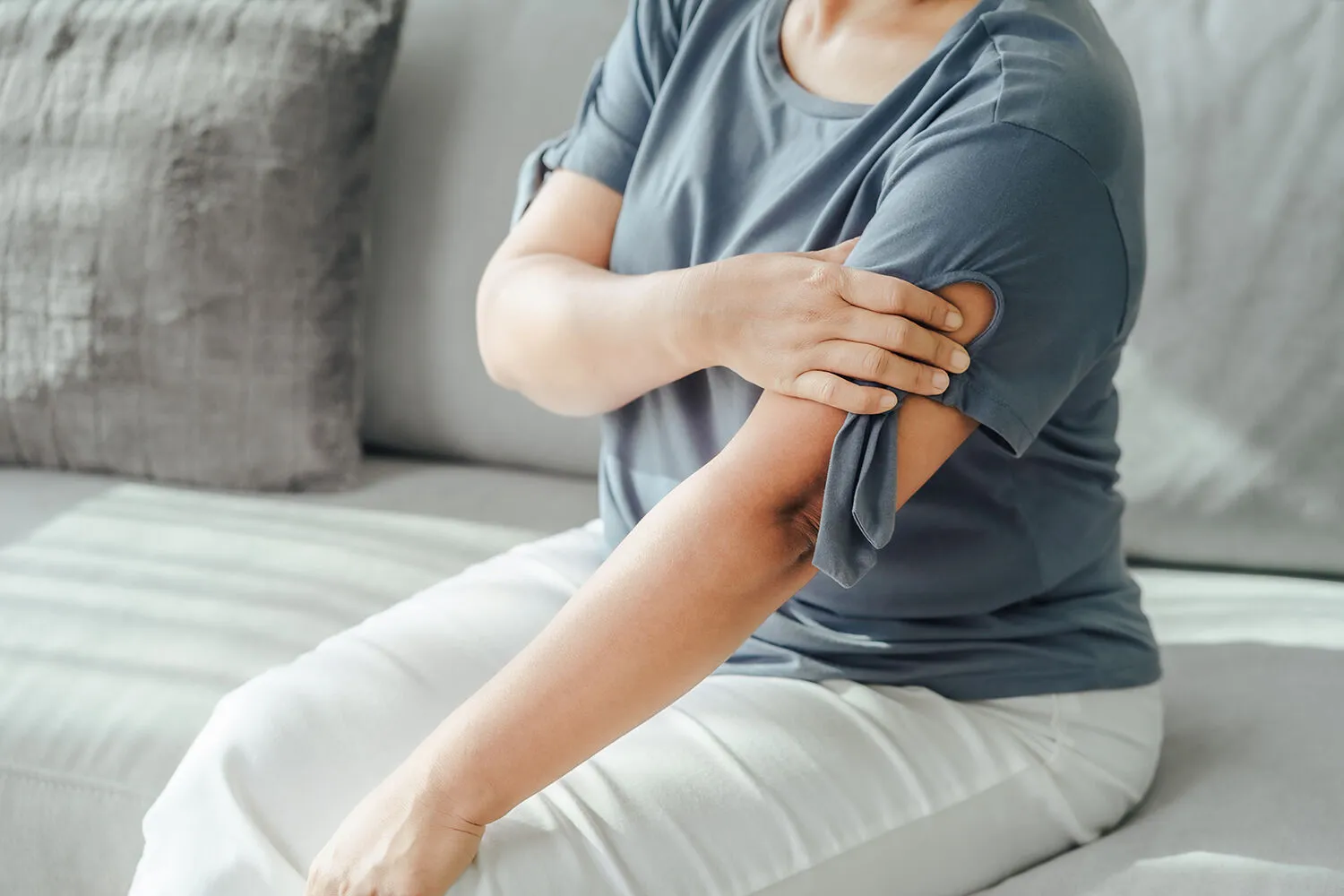 woman touch her shoulder pain